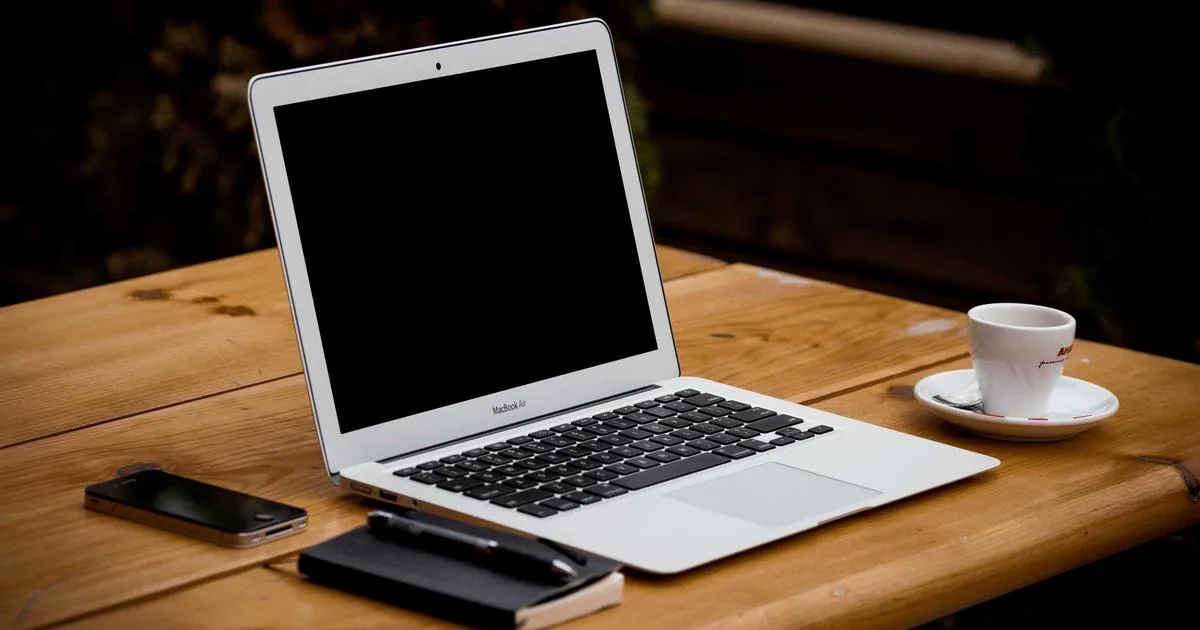 Developer laptop displaying code and domain configuration